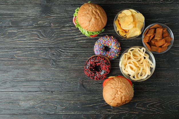 Tasty fast food on rustic wooden table