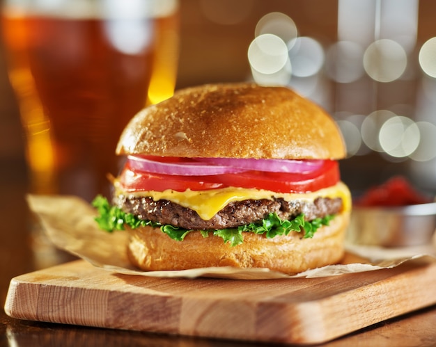 Tasty fast food style cheese burger with beer
