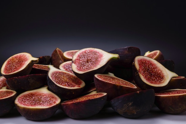 Photo tasty figs on a black background. top view. slices.