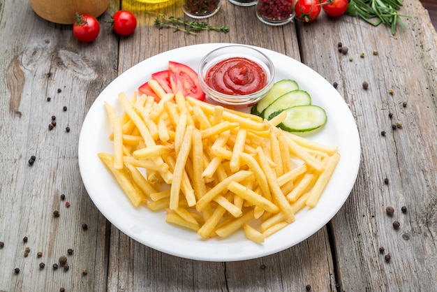 Tasty french fries on cutting board