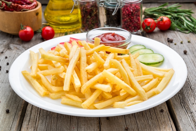 Tasty french fries on wooden table