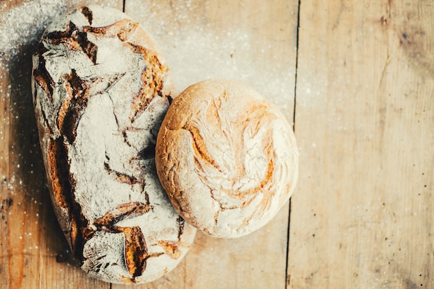 Tasty fresh bread on wooden table 