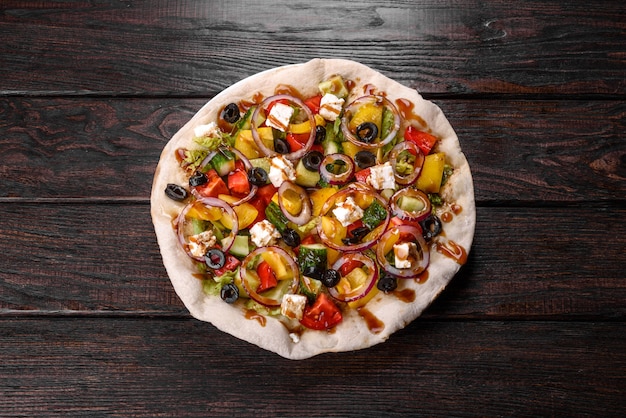 Tasty fresh Greek salad on a pita cooked for a festive table