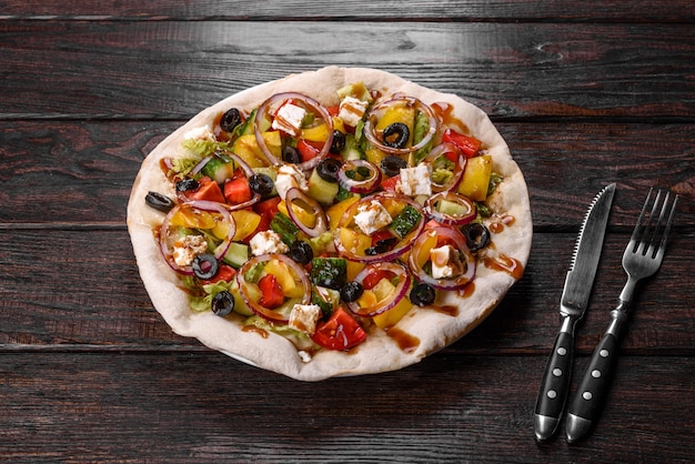 Tasty fresh Greek salad on a pita cooked for a festive table