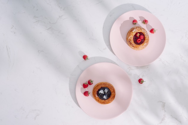 Tasty fresh homemade puff pastry with berries on the white wooden table