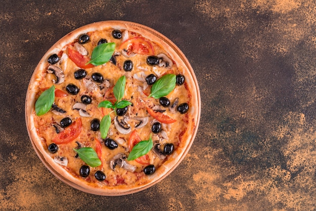 Tasty fresh hot pizza against a dark background