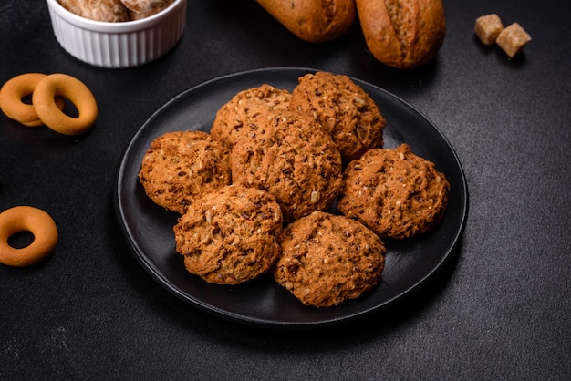 Tasty fresh oat cookies on a dark concrete background Delicious wholesome sweets