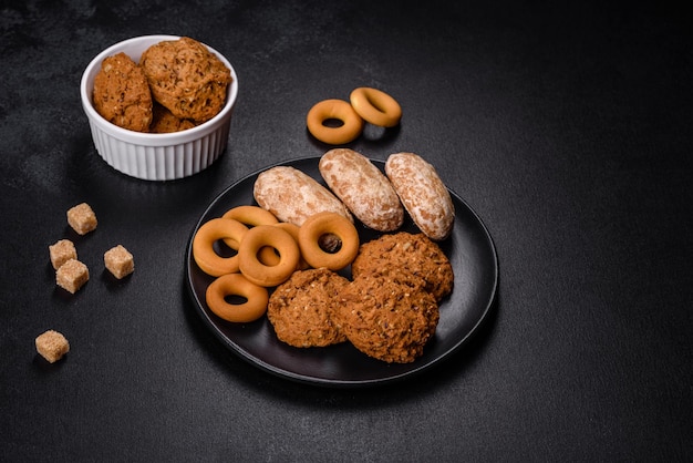 Tasty fresh oat cookies on a dark concrete background Delicious wholesome sweets