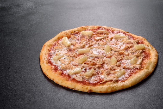 Tasty fresh oven pizza with tomatoes, cheese and pineapple