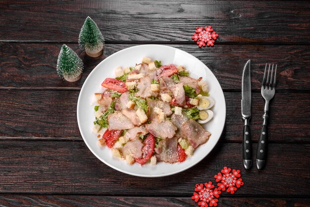 Tasty fresh salad prepared for the Christmas table. Preparation of the festive table