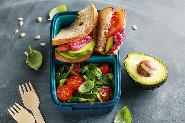 Tasty freshmade healthy vegan lunch to go served in lunch box. Closeup.