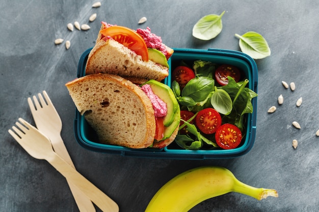 Tasty freshmade healthy vegan lunch to go served in lunch box. Closeup.