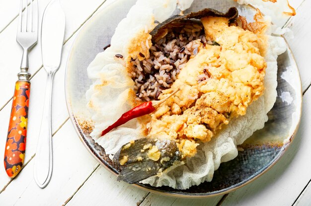 Tasty fried sea bass with rice garnish