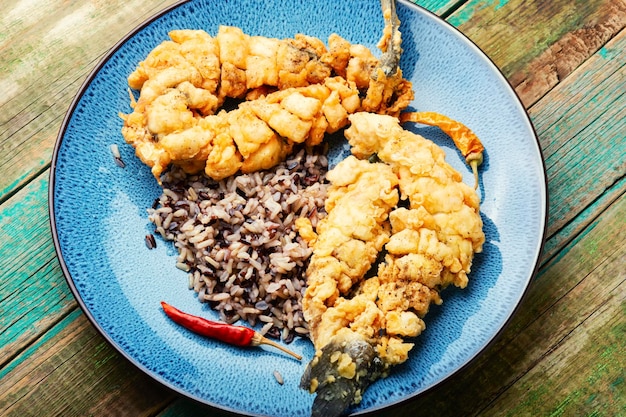 Tasty fried sea bass with rice garnish