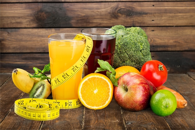 Tasty fruits  and juice with vitamins on background