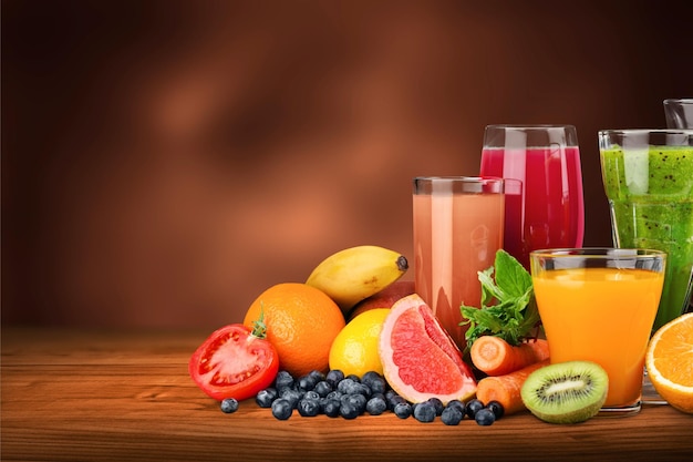 Photo tasty fruits  and juice with vitamins on background