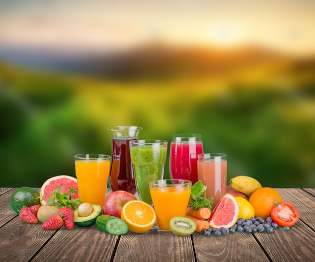 Tasty fruits  and juice with vitamins on background