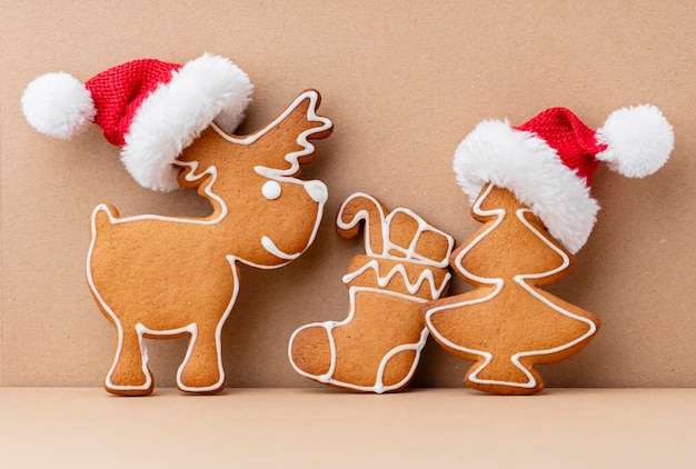 Tasty gingerbread cookies and Christmas decor on pastel background.