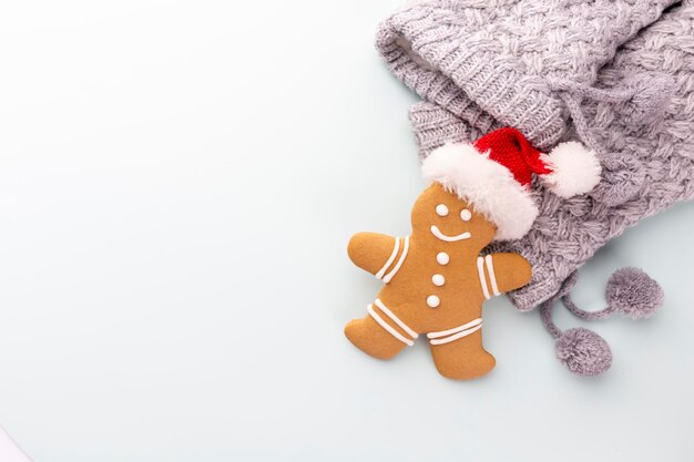 Tasty gingerbread cookies and Christmas decor on pastel background.