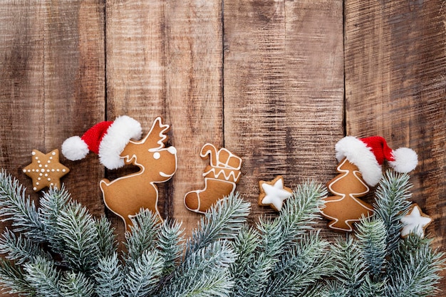 Tasty gingerbread cookies and Christmas decor on pastel background.