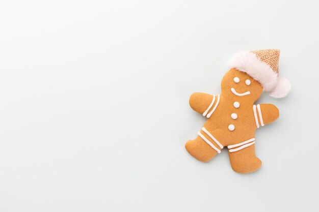 Tasty gingerbread cookies and Christmas decor on pastel background.