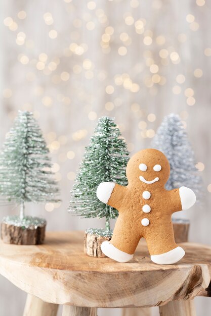 Tasty gingerbread cookies and Christmas decor on wooden background.