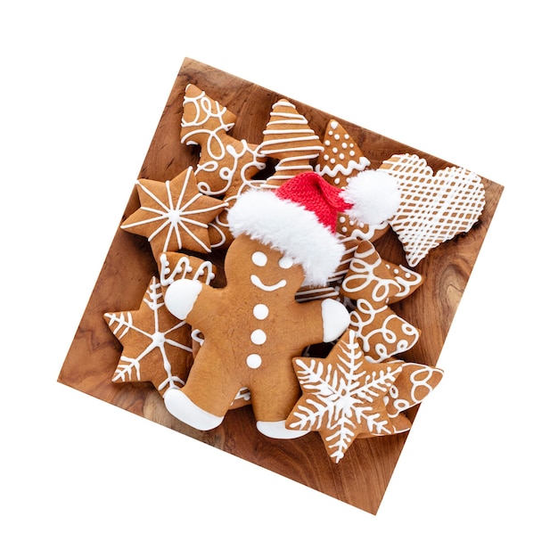 Tasty gingerbread cookies and Christmas decor on wooden background.