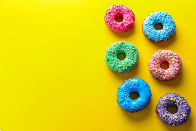 Tasty glazed donuts on color background