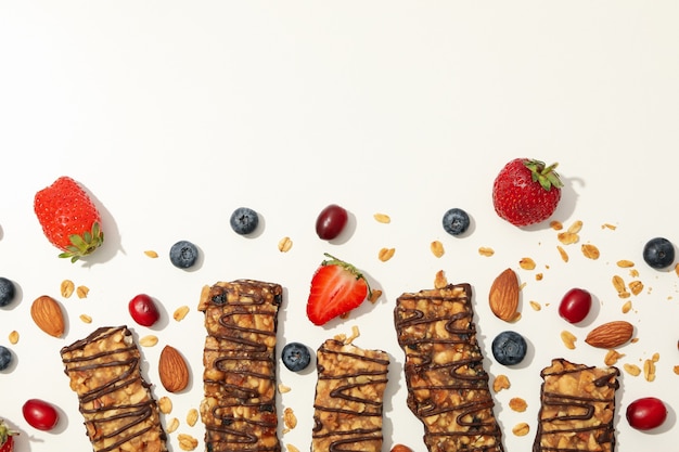 Tasty granola bars on white background, top view