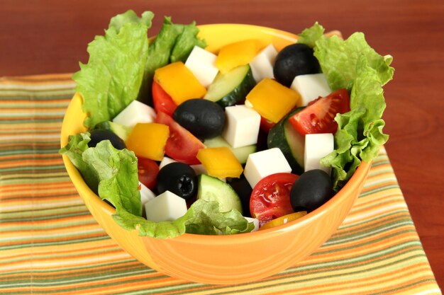 Tasty greek salad on wooden background