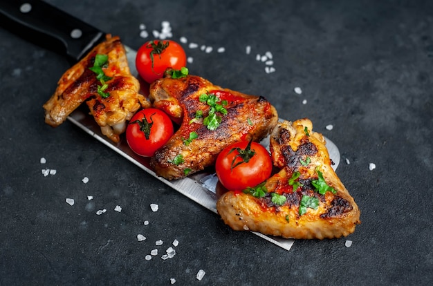 Tasty grilled chicken wings with spices and herbs