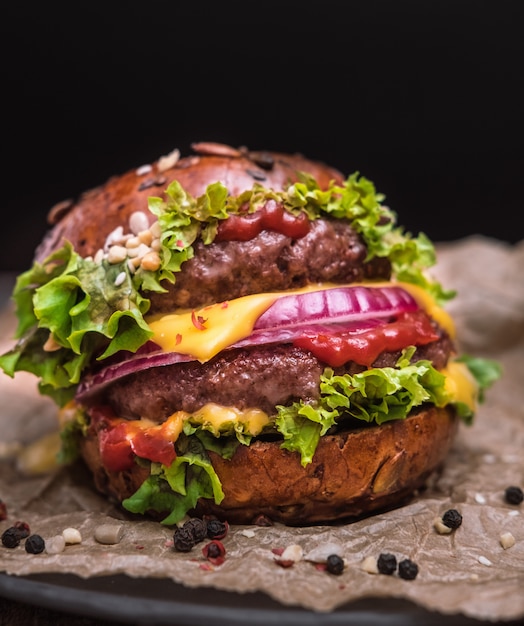 Tasty grilled double burger cheeseburger with pepper and salad