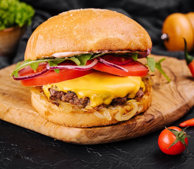 Tasty grilled home made burger with beef tomato cheese onion and lettuce