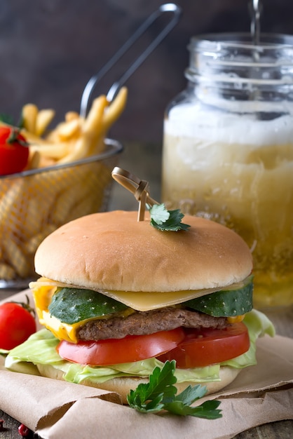 Tasty grilled prawn and beef burger with lettuce and mayonnaise served on pieces of brown 