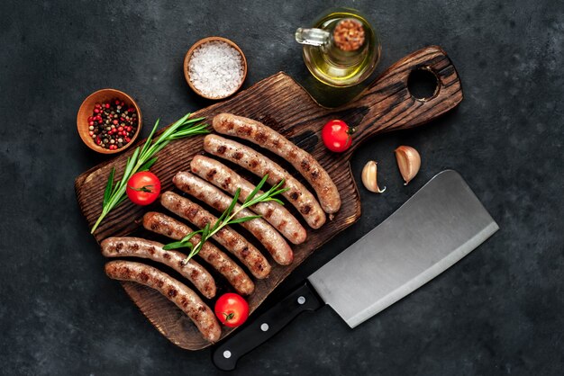 Tasty grilled sausages with spices and rosemary