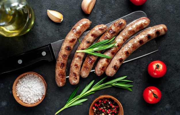 Tasty grilled sausages with spices and rosemary