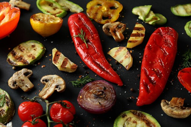 Tasty grilled vegetables on black, close up