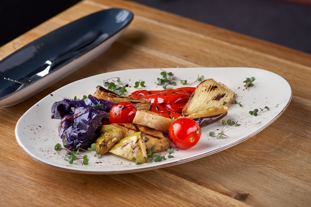Tasty grilled vegetables on pan on wooden table