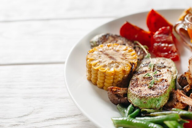 Tasty grilled vegetables on white plate