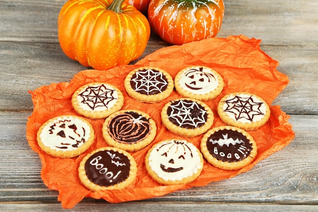 Tasty Halloween cookies on wooden table