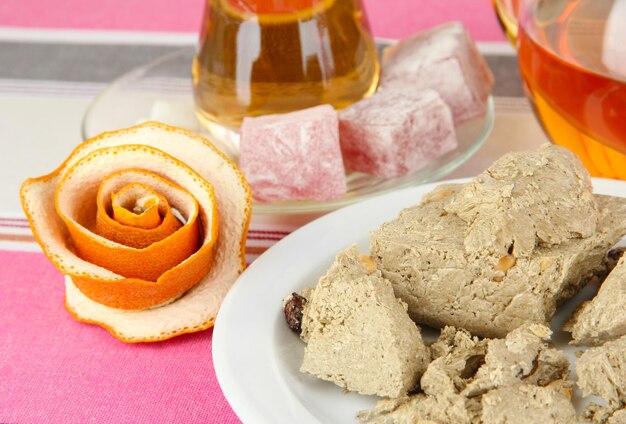 Tasty halva with tea on table closeup