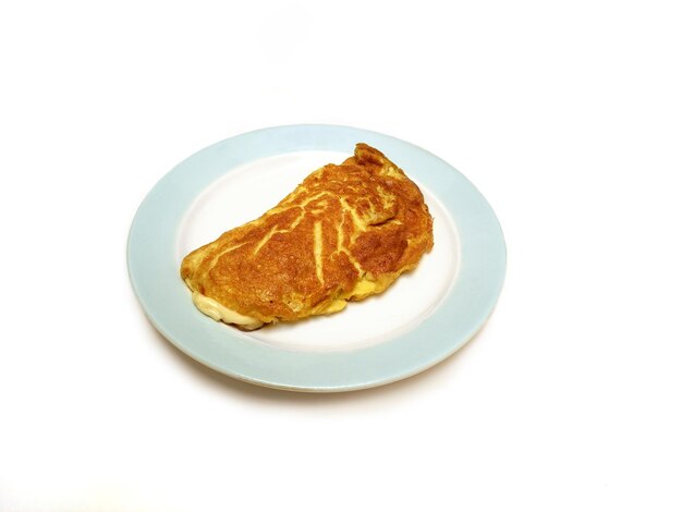 Tasty ham and cheese omelet on a plate for breakfast. Isolated on a white background