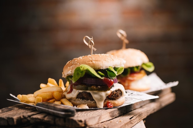 Tasty hamburger on wood background close up