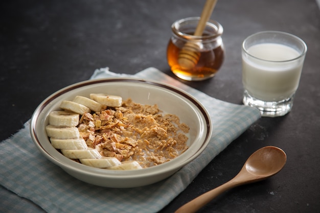 Tasty and healthy breakfast: fruits, corn flakes, milk and honey.