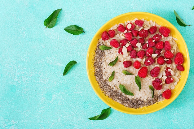 Tasty and healthy oatmeal porridge with raspberry and flax chia. Healthy breakfast. 