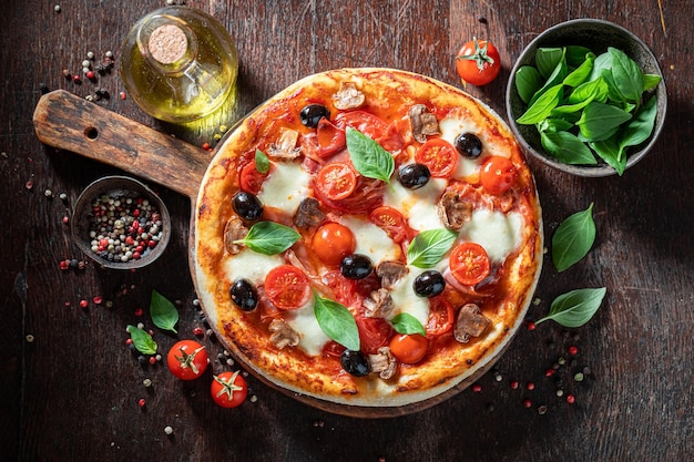 Tasty and healthy pizza Capricciosa with prosciutto mushrooms and cheese