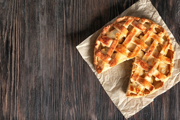 Tasty homemade apple pie on wooden table