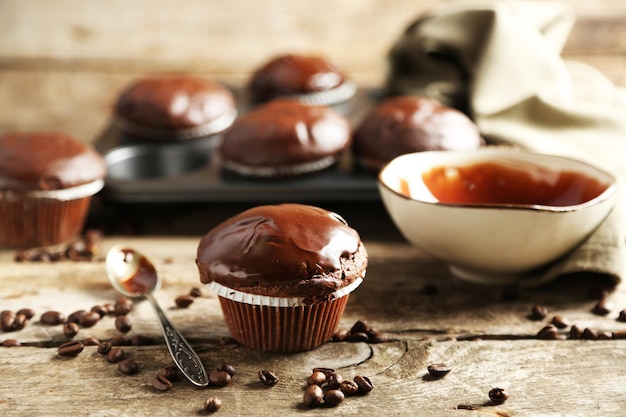 Photo tasty homemade chocolate muffins on wooden table