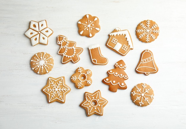 Tasty homemade Christmas cookies on wooden background top view