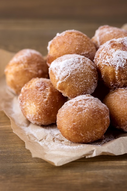 Tasty Homemade Cottage Cheese Donuts in Sugar Powder Wooden Background Donuts Vertical